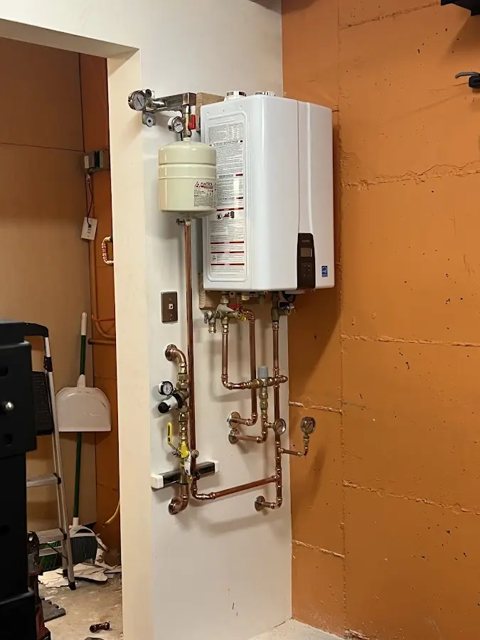 Plumbing technician inspecting water heater connections in Summerlin South